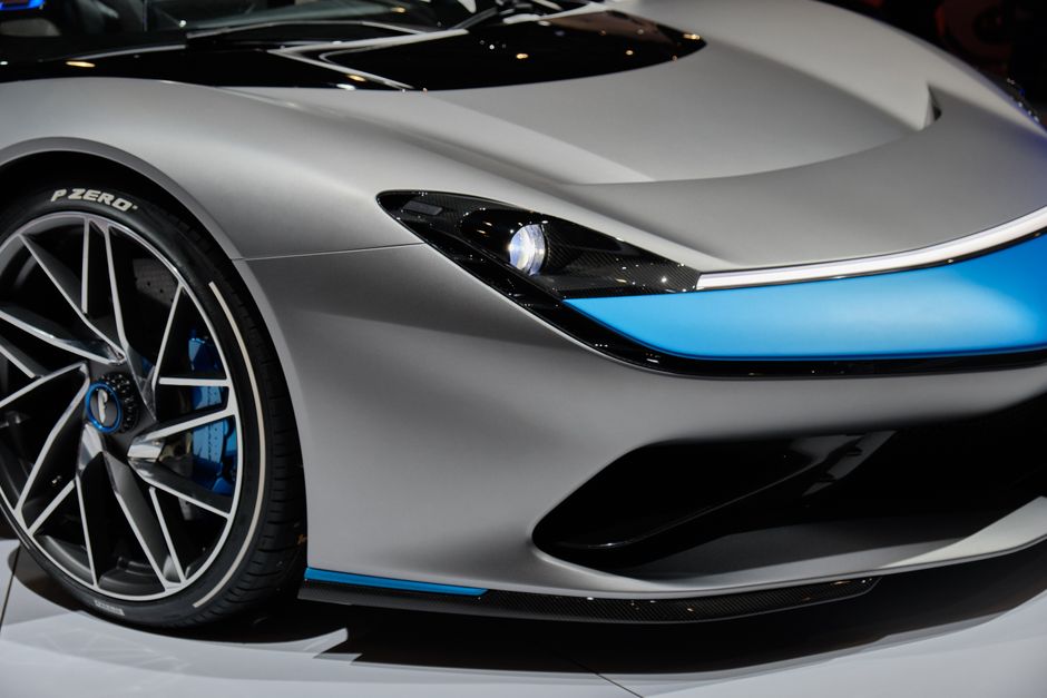 Close-up view of a sleek and modern luxury sports car with alloy rims at an auto show.